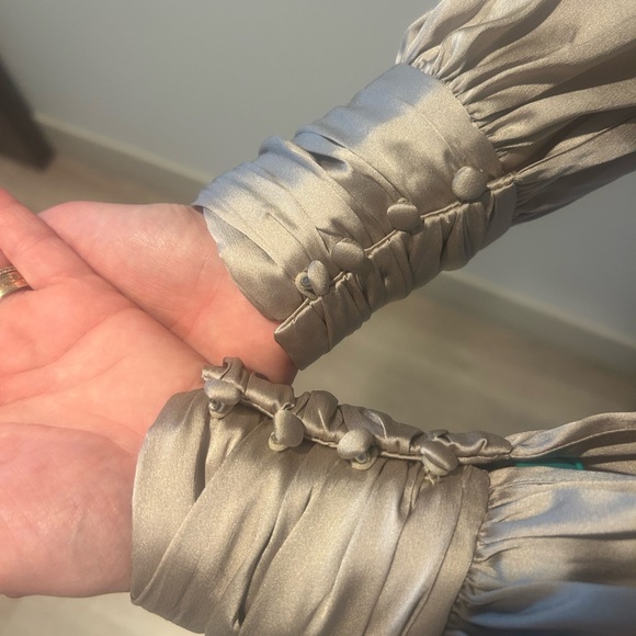 This satin blouse has a twisted neckline keyholes and blouson sleeves for flair - Picture 2 of 7